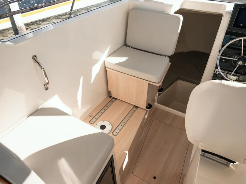 Slide: The Image of 2024 Bayliner Trophy T25PH interior with cushioned seating and steering wheel. - 16