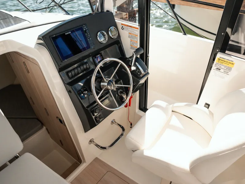 Slide: The Image of 2024 Bayliner Trophy T25PH helm with modern controls and comfortable seating. - 19