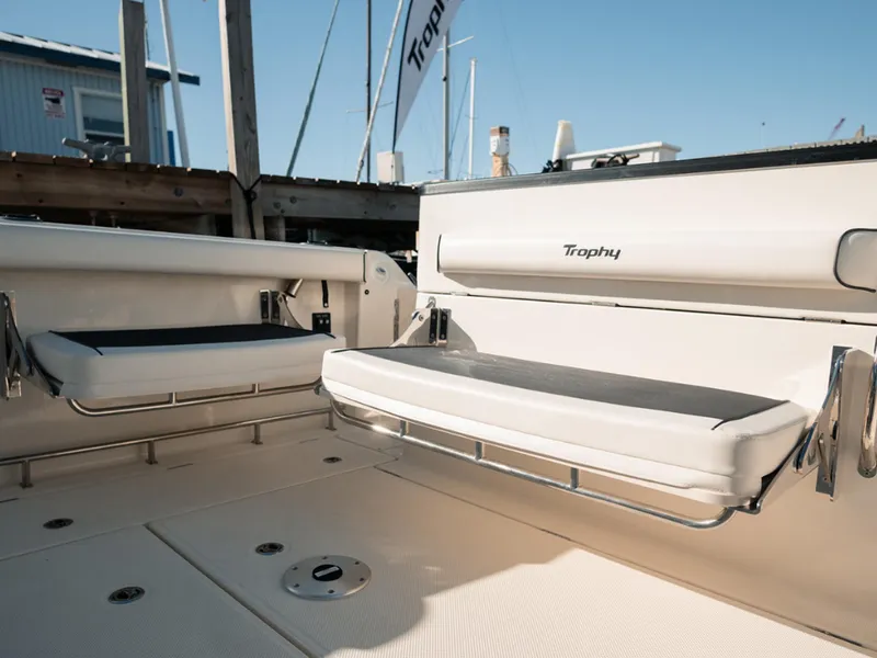 Slide: The Image of 2024 Bayliner Trophy T25PH boat interior with cushioned seating and sleek design. - 22