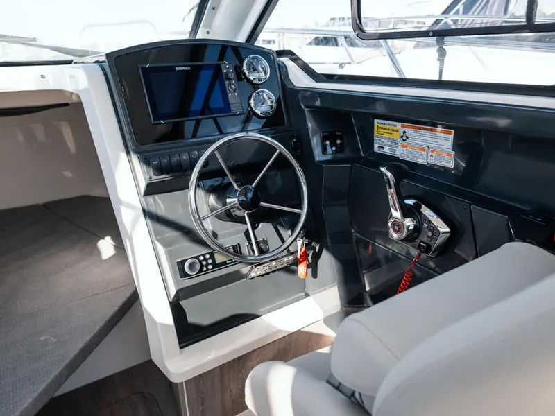 Slide: The Image of 2024 Bayliner Trophy T25PH helm with modern controls and navigation system. - 26