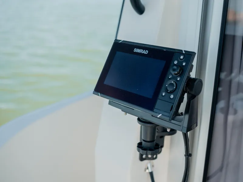 Slide: The Image of Simrad display on 2024 Bayliner Trophy T25PH boat, mounted near water. - 34