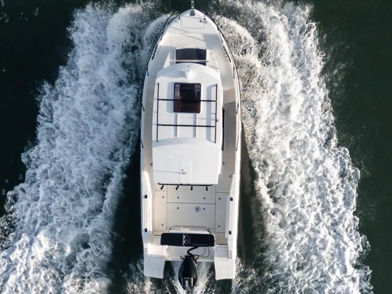 Slide: The Image of 2024 Bayliner Trophy T25PH boat cruising on water, aerial view. - 4