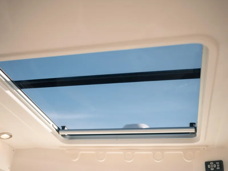 Slide: The Image of 2024 Bayliner Trophy T25PH skylight view with clear blue sky. - 6