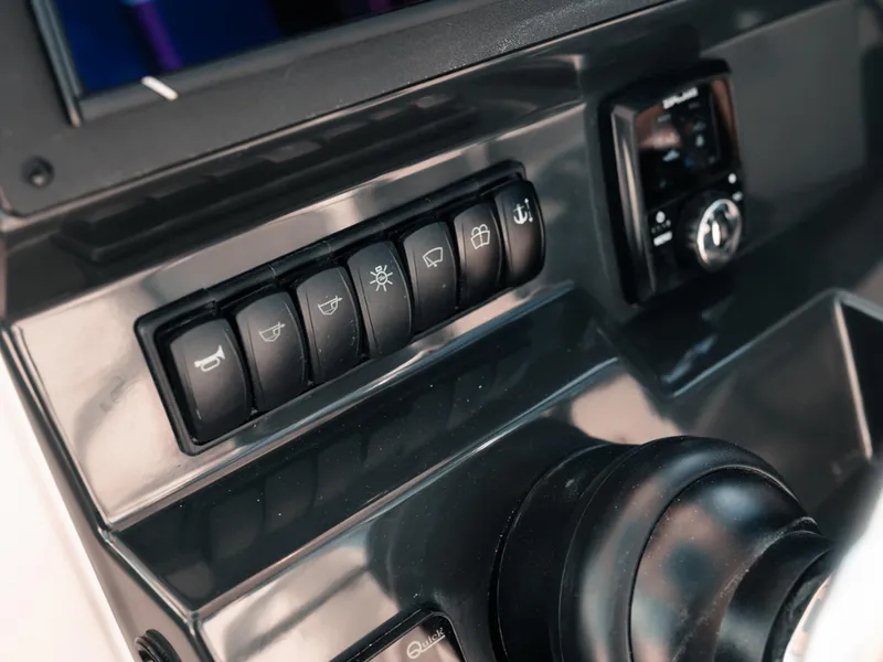 Slide: The Image of Control panel of 2024 Bayliner Trophy T25PH boat with switches and dials. - 7