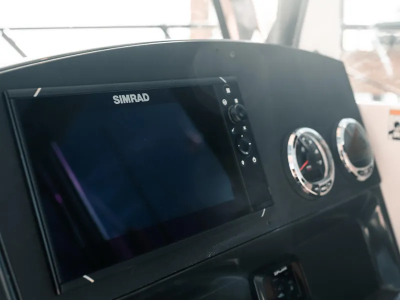 Slide: The Image of 2024 Bayliner Trophy T25PH dashboard with Simrad display and gauges. - 8
