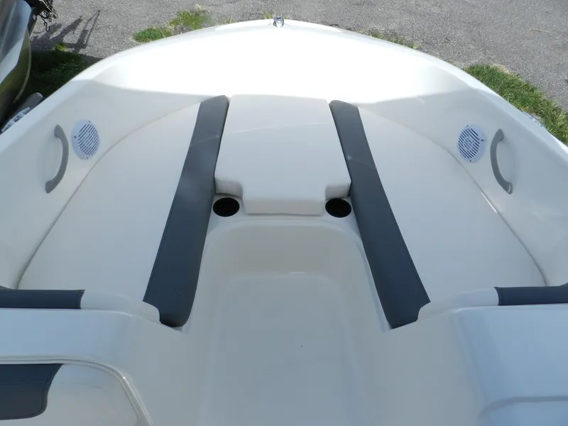 Slide: The Image of 2025 Bayliner E18 boat interior with gray seating and cup holders. - 12