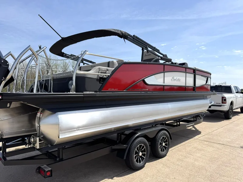 Slide: The Image of 2025 Barletta Lusso 23UC pontoon boat on trailer, red and silver design. - 10
