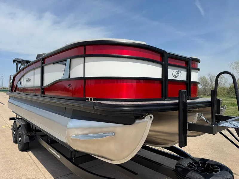 Slide: The Image of 2025 Barletta Lusso 23UC pontoon boat with red and white exterior on a trailer. - 13