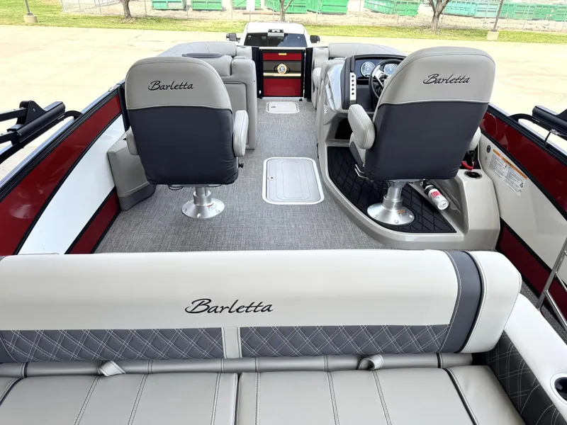 Slide: The Image of 2025 Barletta Lusso 23UC pontoon boat interior with plush seating and modern dashboard. - 20