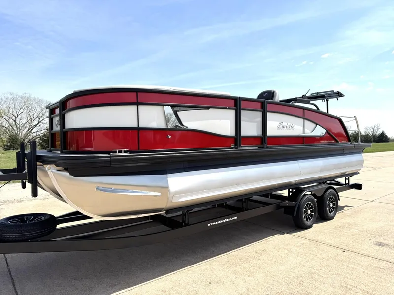 Slide: The Image of 2025 Barletta Lusso 23UC pontoon boat on trailer, featuring sleek red and white design. - 3