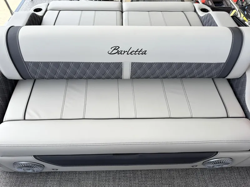 Slide: The Image of 2025 Barletta Lusso 23UC boat seating with elegant stitching and cup holders. - 34