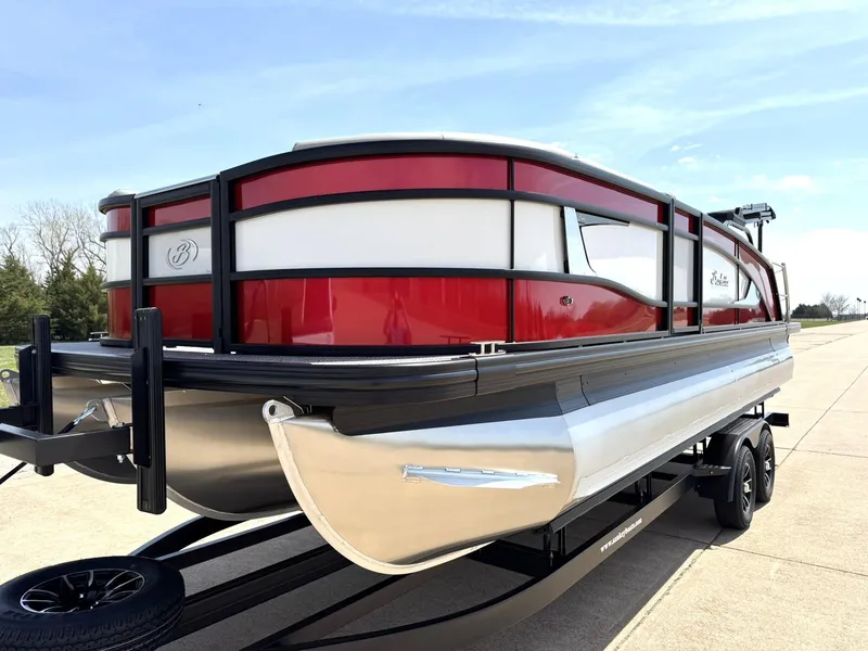 Slide: The Image of 2025 Barletta Lusso 23UC pontoon boat with red and white exterior on a trailer. - 4