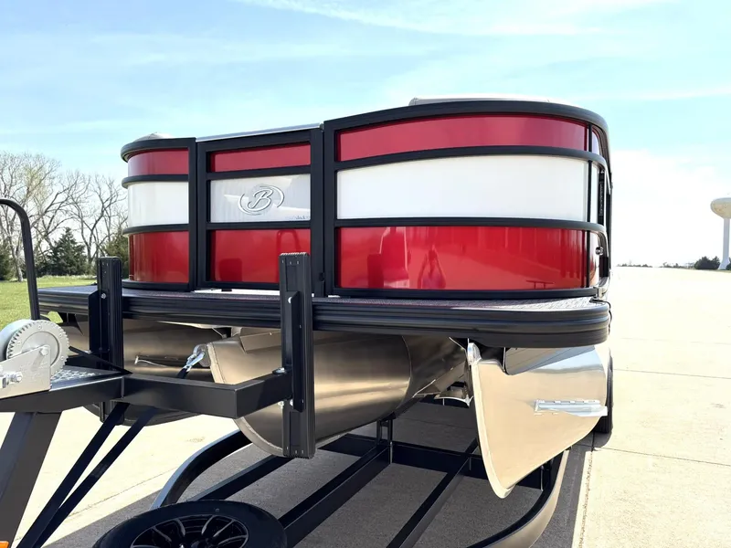 Slide: The Image of 2025 Barletta Lusso 23UC pontoon boat with sleek red and white design on a trailer. - 5