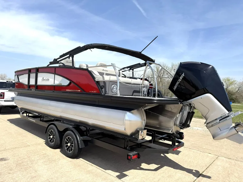 Slide: The Image of 2025 Barletta Lusso 23UC pontoon boat on trailer, featuring sleek design and powerful Mercury engine. - 6