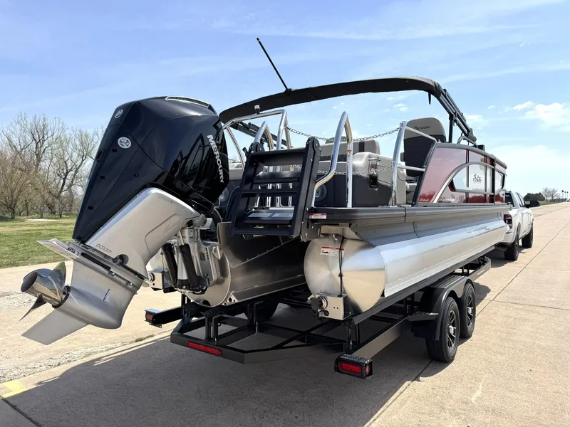 Slide: The Image of 2025 Barletta Lusso 23UC pontoon boat on trailer, featuring powerful outboard motor. - 9