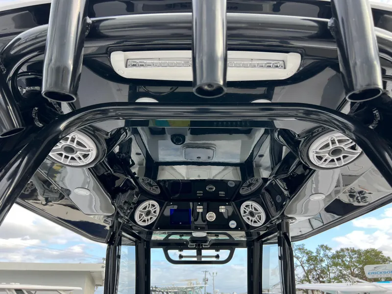 Slide: The Image of 2025 Sportsman Open 322 Center Console boat interior with speakers and control panel. - 16