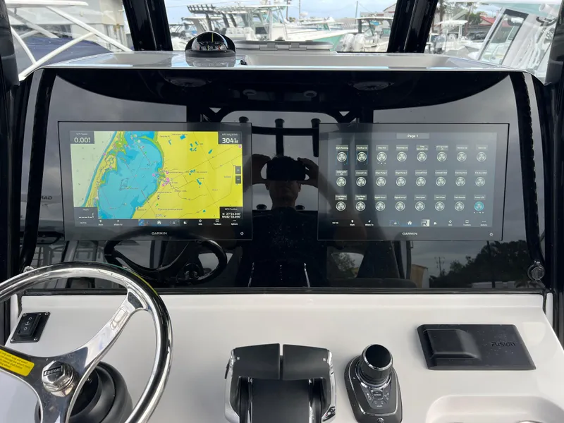 Slide: The Image of 2025 Sportsman Open 322 Center Console dashboard with navigation and control screens. - 17