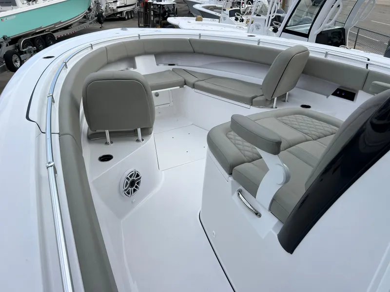 Slide: The Image of 2025 Sportsman Open 322 Center Console boat interior with cushioned seating and modern design. - 18