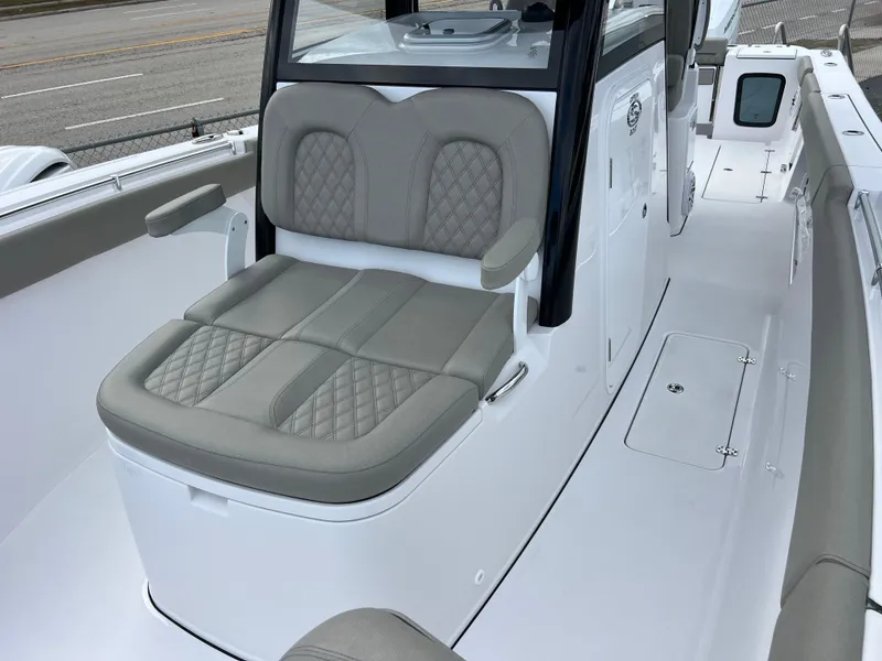 Slide: The Image of 2025 Sportsman Open 322 Center Console boat with cushioned seating and sleek design. - 22
