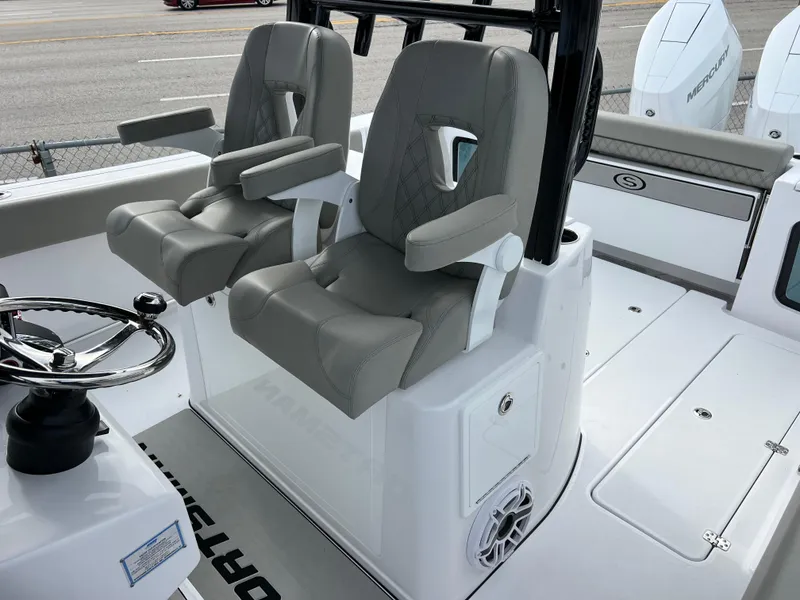 Slide: The Image of 2025 Sportsman Open 322 Center Console boat seats and helm, featuring modern design and comfort. - 23