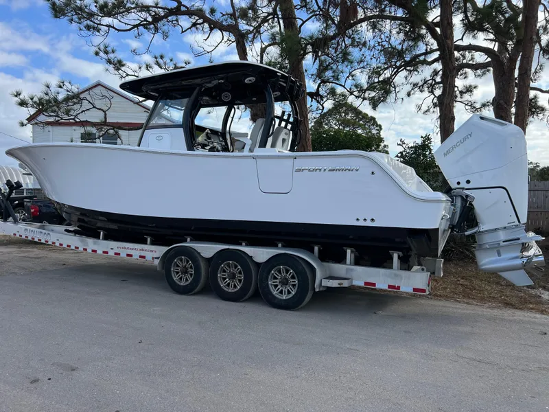 Slide: The Image of 2025 Sportsman Open 322 Center Console boat on trailer, parked outdoors. - 3