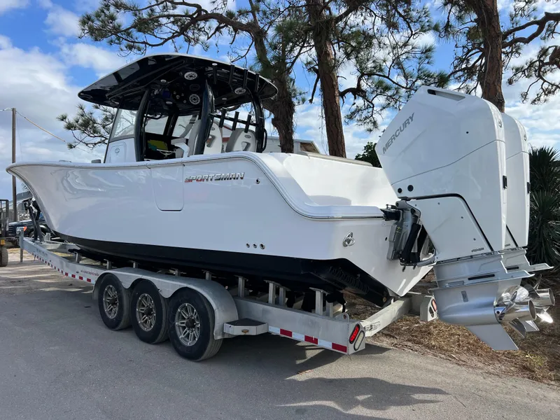 Slide: The Image of 2025 Sportsman Open 322 Center Console boat on trailer, parked outdoors. - 4