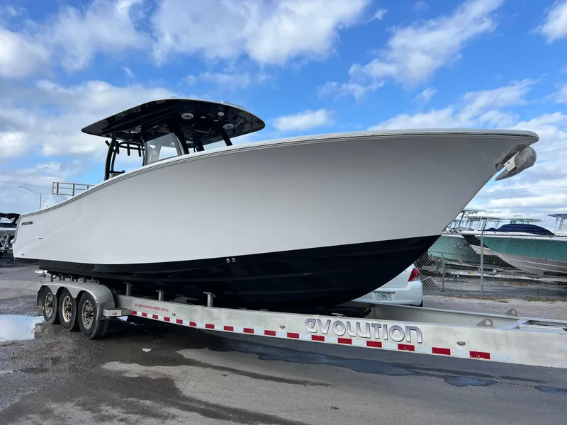 Slide: The Image of 2025 Sportsman Open 322 Center Console boat on trailer under cloudy sky. - 5