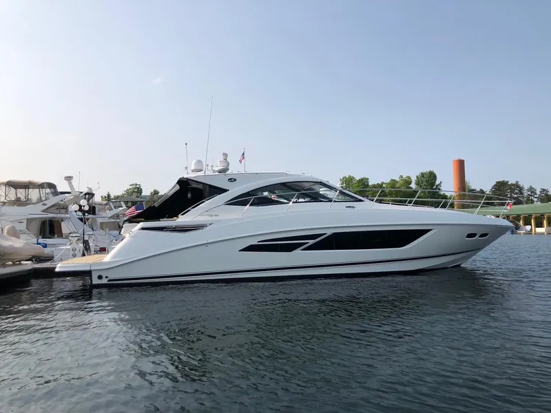 Slide: The Image of 2014 Sea Ray 510 Sundancer yacht docked on calm water. - 2