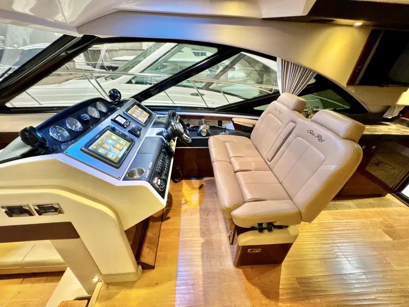 Slide: The Image of Luxurious 2014 Sea Ray 510 Sundancer helm with leather seating and modern controls. - 25