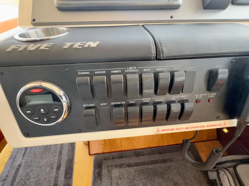 Slide: The Image of Control panel of a 2014 Sea Ray 510 Sundancer boat with various switches and controls. - 29