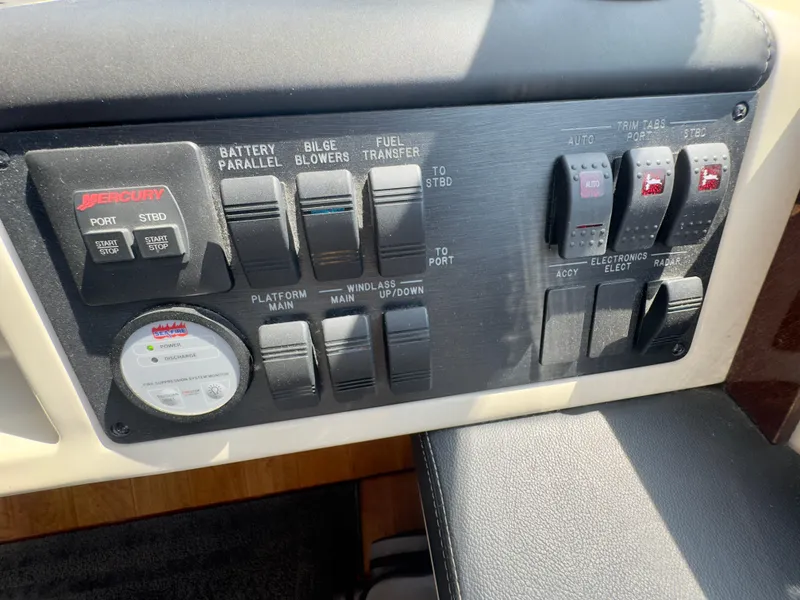 Slide: The Image of Control panel of a 2014 Sea Ray 510 Sundancer boat with various switches and indicators. - 30