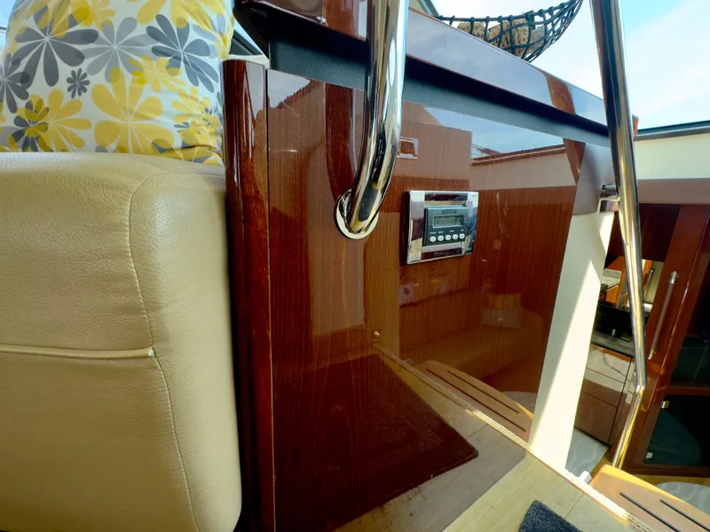 Slide: The Image of Interior of 2014 Sea Ray 510 Sundancer yacht with plush seating and control panel. - 31
