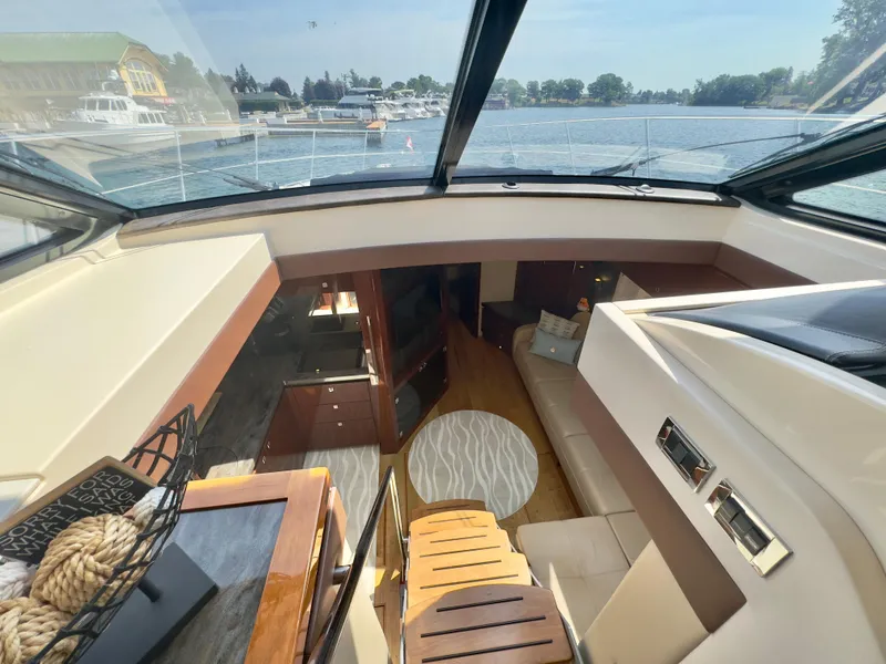 Slide: The Image of Interior view of 2014 Sea Ray 510 Sundancer yacht with luxurious seating and scenic water backdrop. - 33