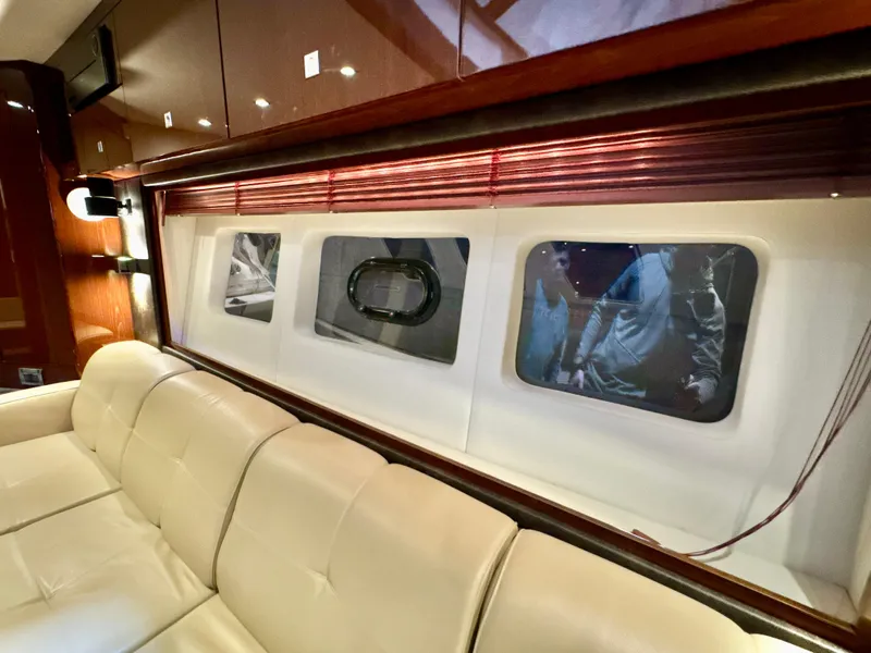 Slide: The Image of Luxurious interior of 2014 Sea Ray 510 Sundancer yacht with plush seating and elegant windows. - 36