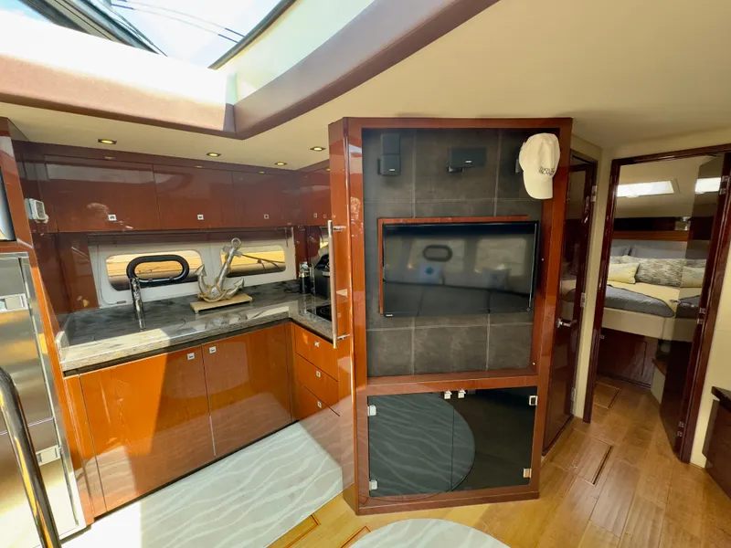 Slide: The Image of Luxurious interior of 2014 Sea Ray 510 Sundancer yacht with modern kitchen and cozy bedroom. - 37