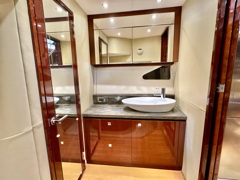 Slide: The Image of Luxurious bathroom in 2014 Sea Ray 510 Sundancer yacht with modern sink and mirrored cabinets. - 42