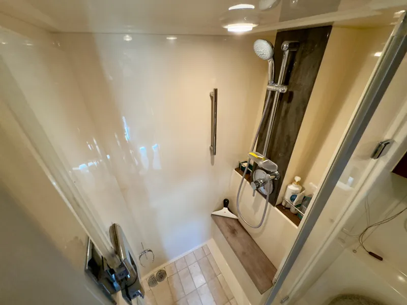 Slide: The Image of Shower area in 2014 Sea Ray 510 Sundancer yacht, featuring modern fixtures and storage. - 45