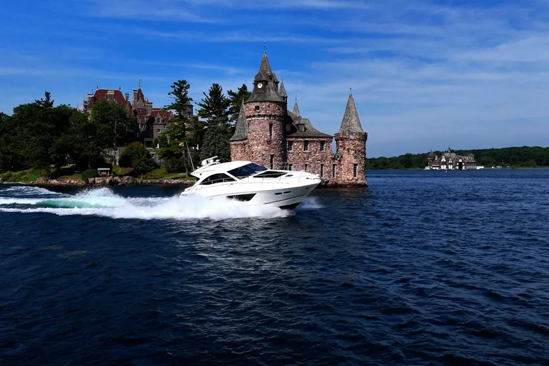 Slide: The Image of 2014 Sea Ray 510 Sundancer cruising near a historic castle on a sunny day. - 5