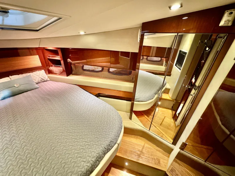 Slide: The Image of Luxurious bedroom interior of 2014 Sea Ray 510 Sundancer yacht with elegant wood finishes. - 50