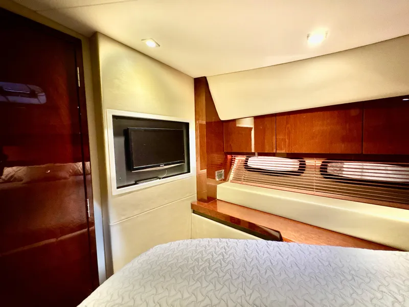 Slide: The Image of Luxurious interior of 2014 Sea Ray 510 Sundancer yacht with TV and elegant wood finishes. - 51