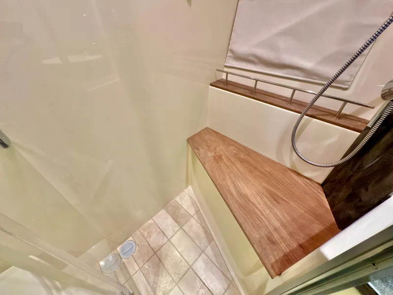 Slide: The Image of Luxurious shower area in 2014 Sea Ray 510 Sundancer yacht with wooden bench and handheld showerhead. - 56