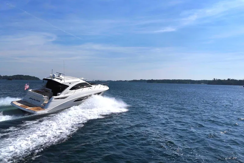 Slide: The Image of 2014 Sea Ray 510 Sundancer cruising on open water under a clear sky. - 7