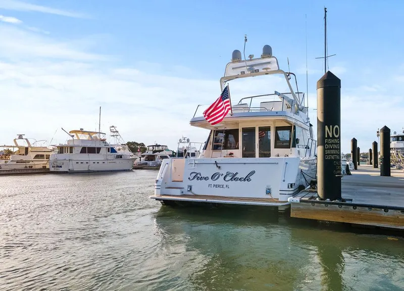 The Image of West Bay 58 Sonship yacht docked at marina, displaying American flag, 2000 model. - 0