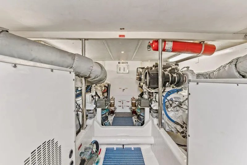 Slide: The Image of Engine room of 2000 West Bay 58 Sonship yacht, featuring mechanical equipment and fire extinguisher. - 35