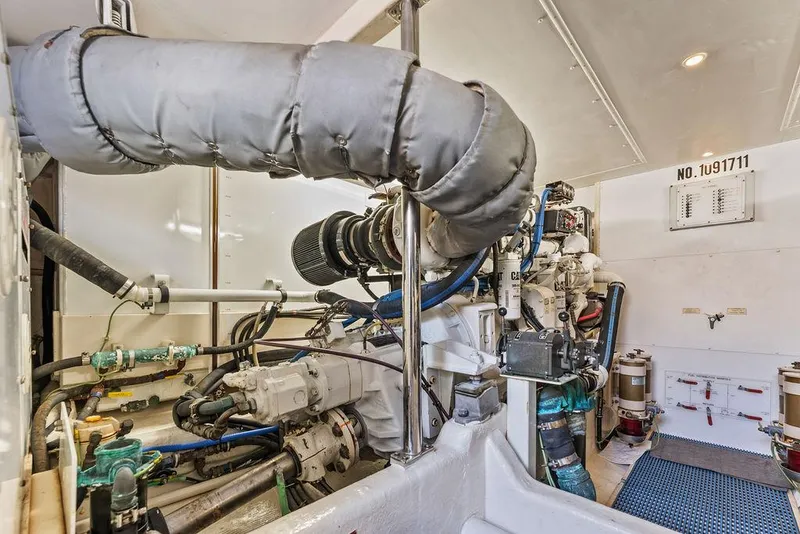 Slide: The Image of Engine room of 2000 West Bay 58 Sonship yacht, showcasing mechanical components and piping. - 37