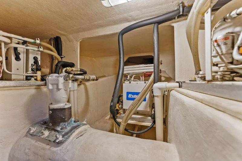 Slide: The Image of Engine room of 2000 West Bay 58 Sonship yacht, showcasing mechanical components and piping. - 43