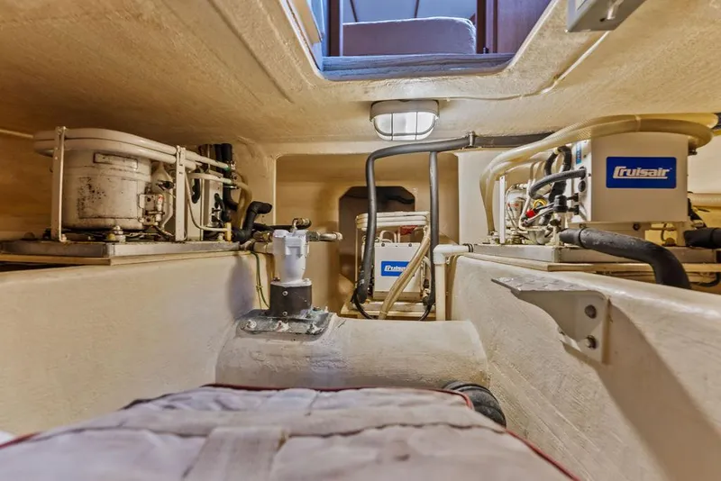 Slide: The Image of Engine room of 2000 West Bay 58 Sonship yacht, featuring mechanical equipment and piping. - 44