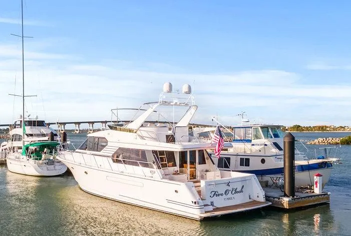 Slide: The Image of 2000 West Bay 58 Sonship yacht docked at marina under clear blue sky. - 47