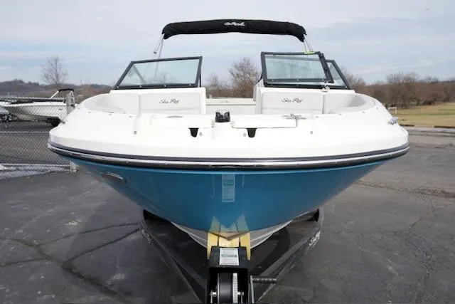 Slide: The Image of 2021 Sea Ray SPX 230 boat on trailer, front view, blue hull, parked outdoors. - 3