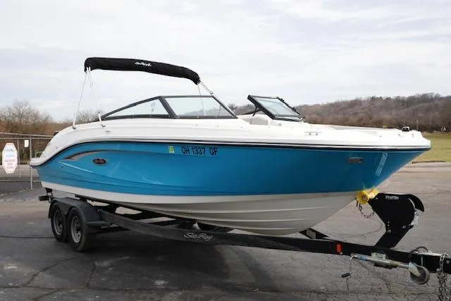 Slide: The Image of 2021 Sea Ray SPX 230 boat on trailer, blue and white design, parked outdoors. - 4